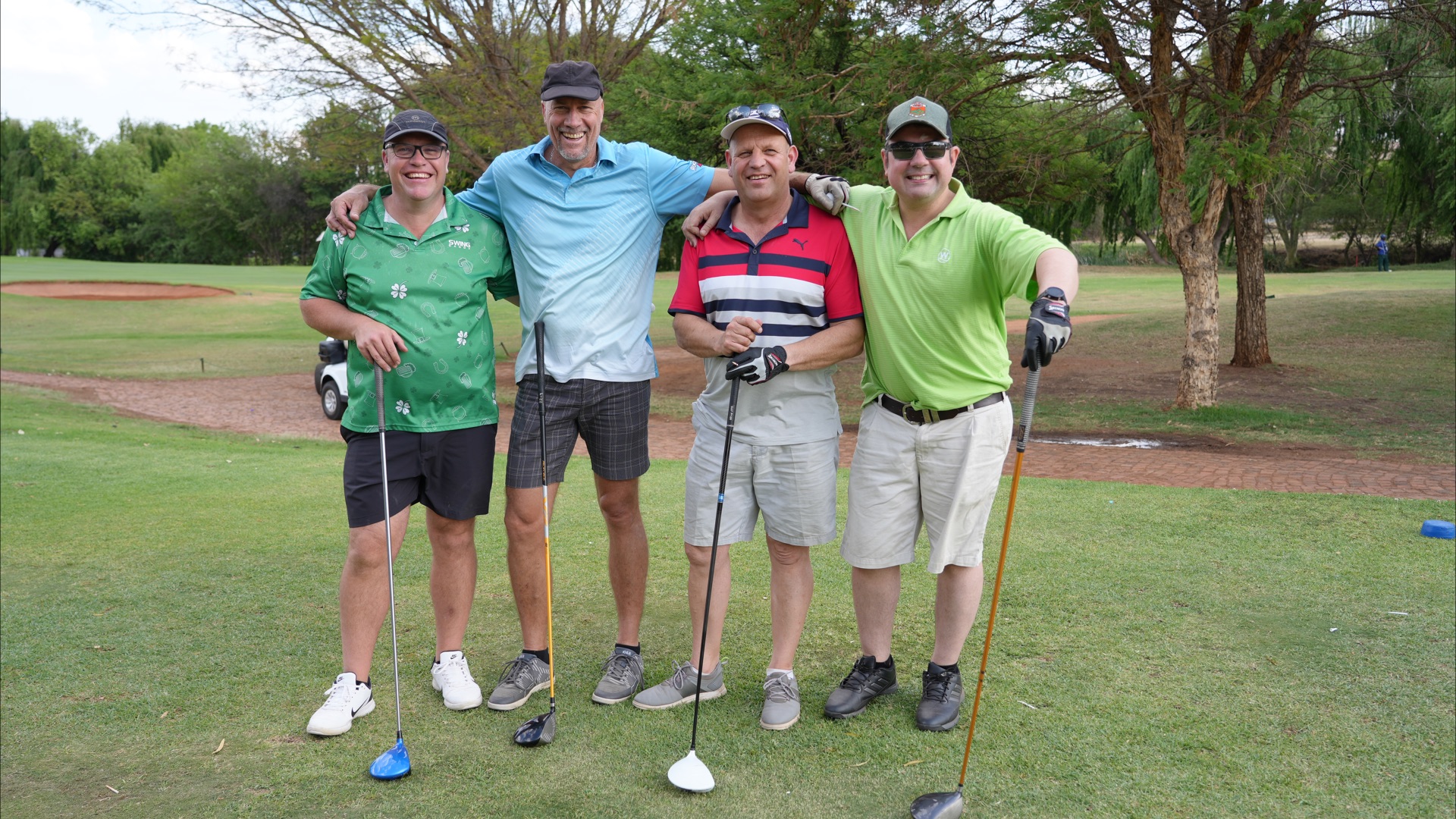 A fourball laughing together on the tee box